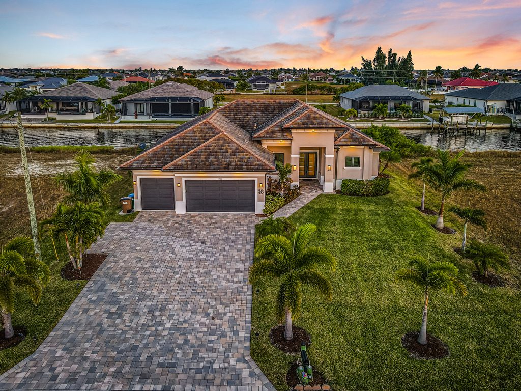 Aerial twilight photo of a new construction waterfront home in Cape Coral, Florida